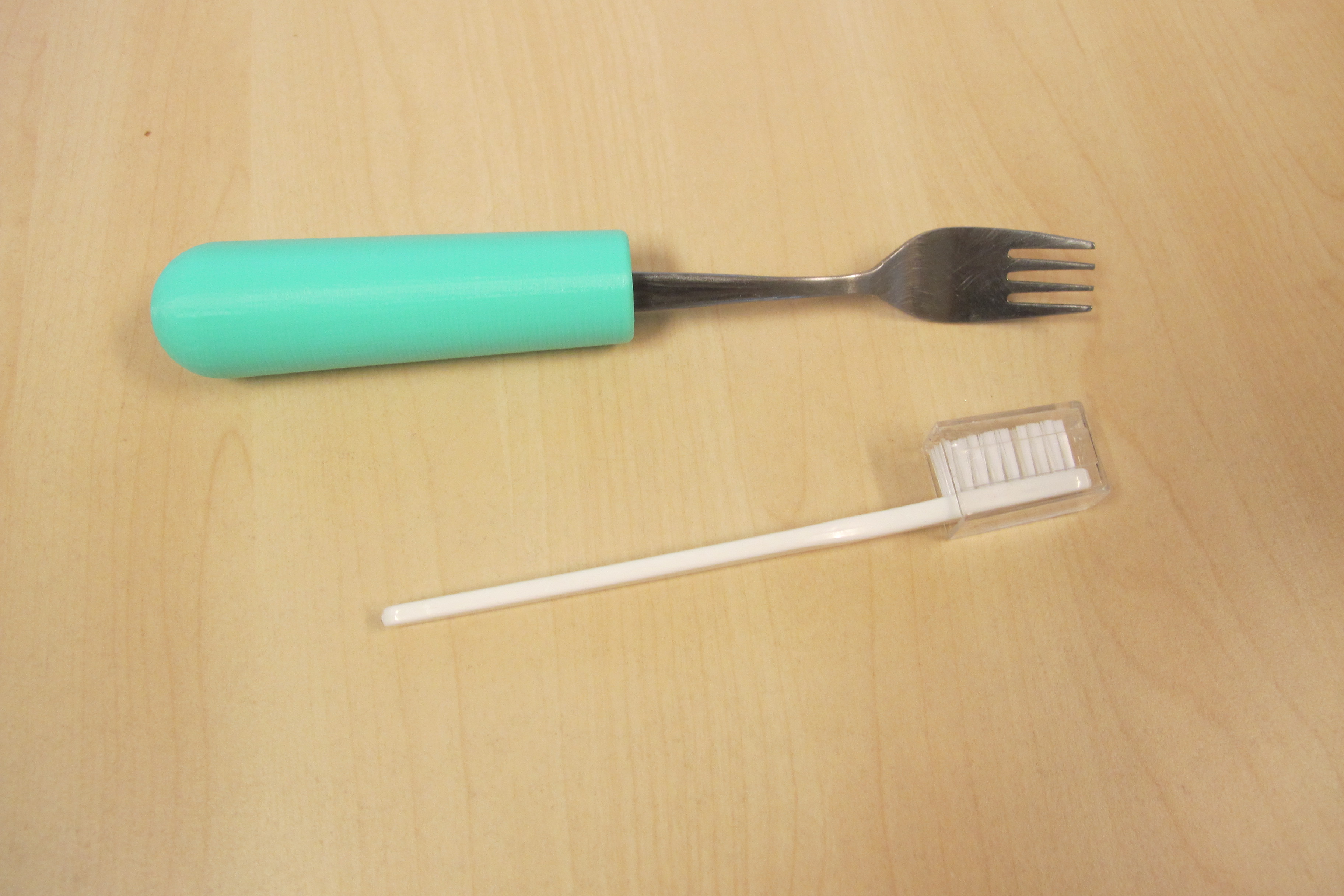 Engrosador con un tenedor y fuera un cepillo de dientes.. Acceso a la galería. Abre nueva ventana